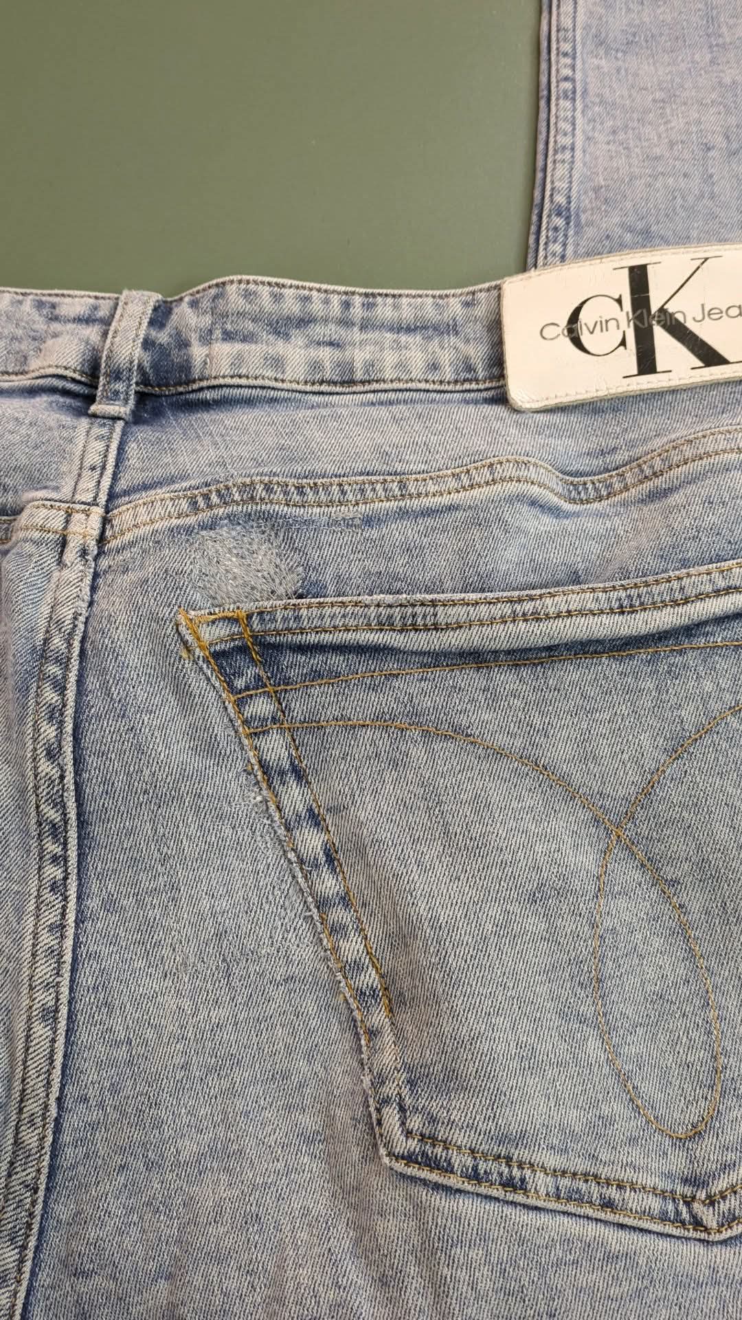 Close-up of a pair of jeans with a Calvin Klein label.