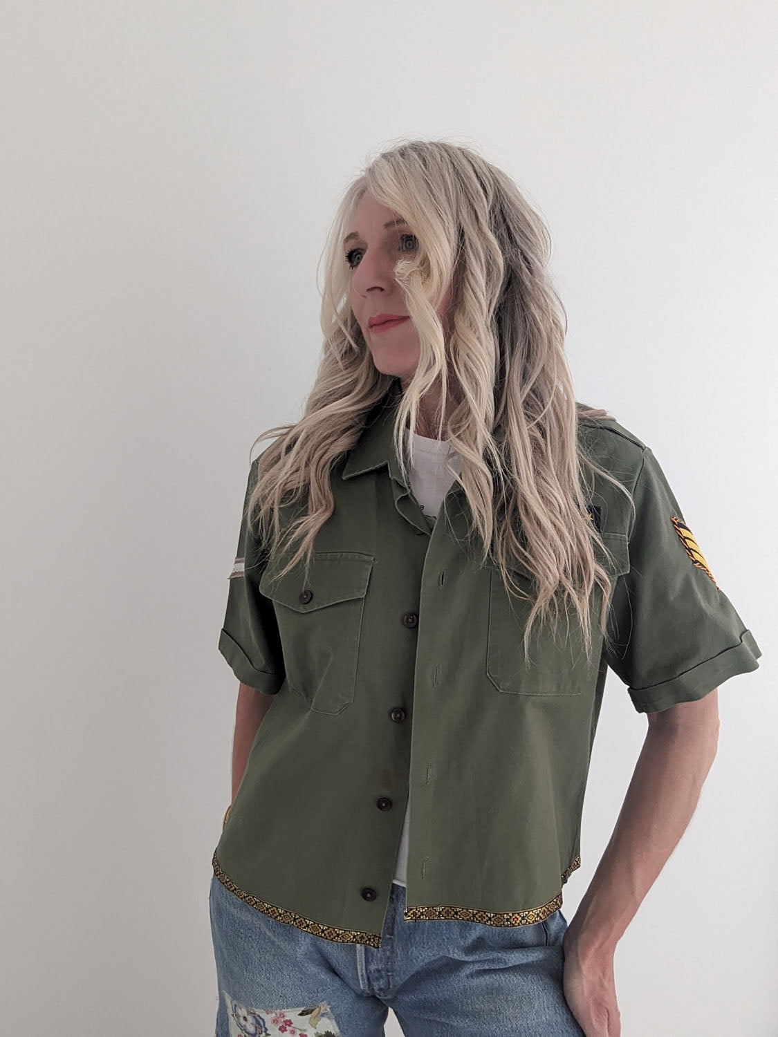 Person wearing a green shirt with a white background