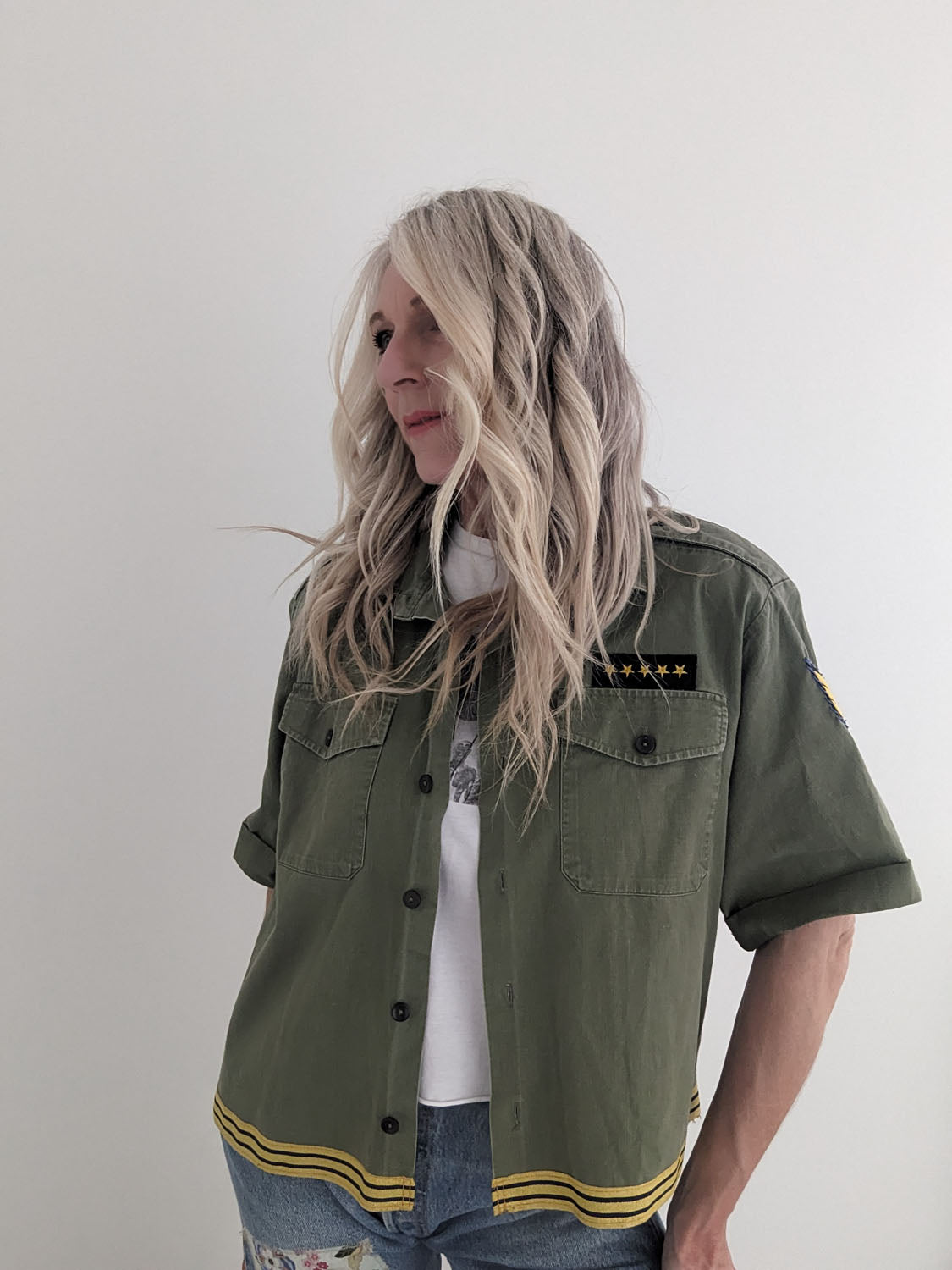 Person wearing a green jacket with a white background